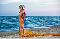 Colorful, vibrant, and enchanting model evoking a sexy sea gypsy by the beach.