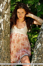 Charming, natural, and carefree beauty amidst lush vegetation.